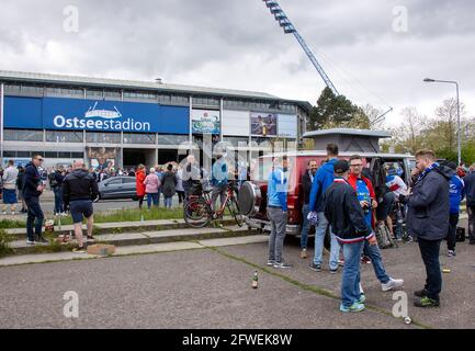 Rostock, Germany. 22nd May, 2021. Football: 3. league, Hansa Rostock - VfB Lübeck, 38th matchday: Fans of FC Hansa Rostock wait outside the Ostseestadion for the start of the match against VfB Lübeck. 7,500 spectators are admitted to the match for promotion to the second Bundesliga, but thousands of fans are also outside the stadium. Credit: -/dpa-Zentralbild/dpa/Alamy Live News Stock Photo