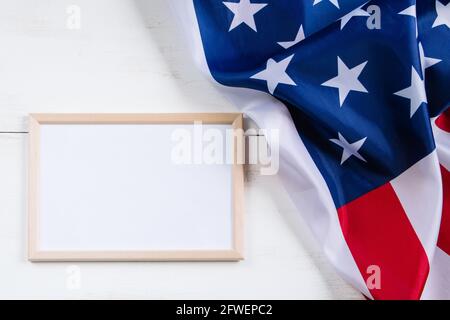 American flag and empty frame for text on white background. Culture of the USA. Concept for independence, memorial day or labor day. Stock Photo