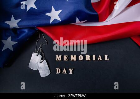 Memorial day concept. American flag and military dog tags on a black background. Remember and honor. Stock Photo