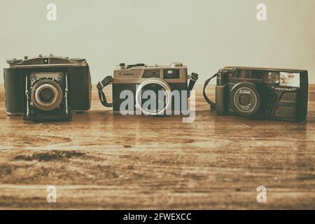 Three vintage cameras from the 1950s, 1970s and 1980s Stock Photo