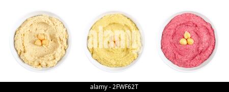 Hummus dips, in white bowls. Middle Eastern dip, a spread made of cooked, mashed chickpeas, blended with tahini, lemon juice and garlic. Stock Photo