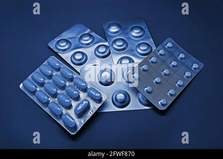 Blister packs of pills on blue tones Stock Photo