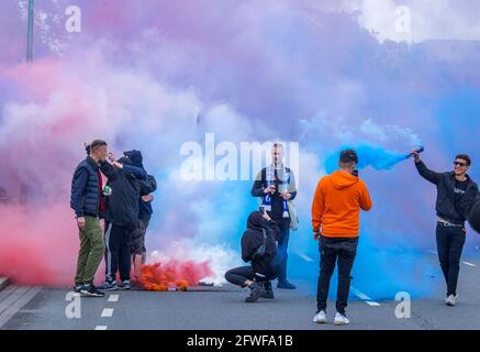 Rostock, Germany. 22nd May, 2021. Football: 3. league, Hansa Rostock - VfB Lübeck, 38th matchday: Fanbs of FC Hansa Rostock celebrate after the match against VfB Lübeck in front of the Ostseestadion the promotion to the second league and burn pyrotechnics. Credit: Jens Büttner/dpa-Zentralbild/dpa/Alamy Live News Stock Photo