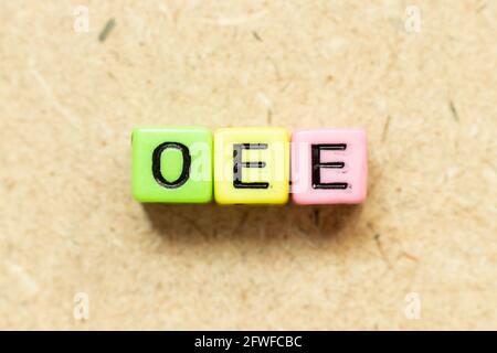 Color alphabet letter block in word OEE (abbreviation of overall equipment effectiveness) on wood background Stock Photo