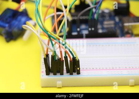 Breadboard with jumper wires connection close-up. Electronics prototyping project concept shown using breadboard and wire connections Stock Photo