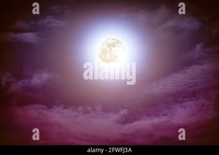 Attractive photo of background nighttime sky with cloud and bright full moon with shiny. Nightly sky with beautiful full moon. Outdoors at night. The Stock Photo