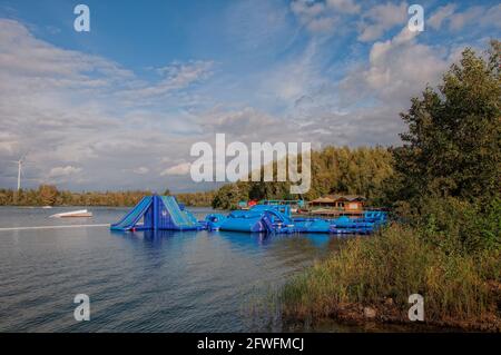 Terhills Cablepark Amusement Park. Wakeboard. A man water skiing on a lake Terhills Cablepark Amusement Park. Wakeboard. A man water skiing on a lake