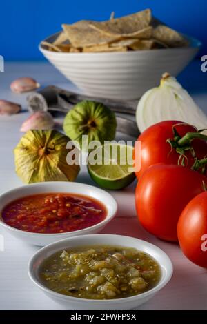 Corn tortilla chips and salsa with raw ingredients. Stock Photo