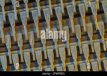 Macro shot of semiconductor microchip connector pins (Mitsubishi brand). For abstract electronics components, microchip pinouts, industrial abstract. Stock Photo