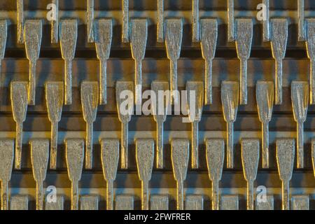 Macro shot of semiconductor microchip connector pins (Mitsubishi brand). For abstract electronics components, microchip pinouts, industrial abstract. Stock Photo