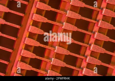 Macro shot of semiconductor microchip connector pins (Mitsubishi brand). For abstract electronics components, microchip pinouts, industrial abstract. Stock Photo