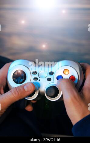 Overhead shot of a man's hands holding a video game controller. Stock Photo