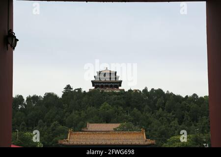 Distant view of Wanchun Pavilion on Prospect Hill at Jingshan Park viewed from The Forbidden City in Beijing, China. Stock Photo