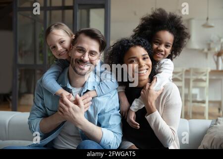 Portrait of happy multiethnic family with diverse kids Stock Photo