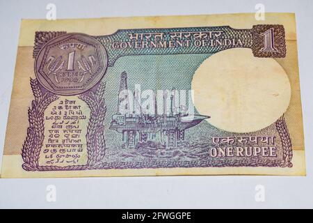 Indian One rupee currency note on white background, Government of india one rupee old banknote indian currency, Old Indian Currency note on the table Stock Photo