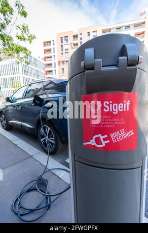 Bois-Colombes, France - May 22, 2021: Electric car charging station belonging to the SIGEIF network (Intercommunal Syndicate for Gas and Electricity i Stock Photo