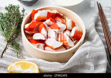 Crab sticks seafood semi finished fish mince with blue swimming crab set, on wooden tray, on white background Stock Photo
