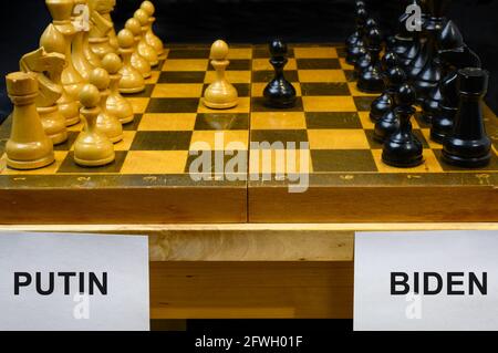 Russia vs USA, chess like geopolitics game. The names Putin and Biden by chessboard. Concept of summit meeting, political tension, economy war, sancti Stock Photo