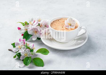 Violet cup of morning coffee or cappuccino and delicate purple, lilac  flowers. Mother's day concept. Cozy breakfast Stock Photo - Alamy