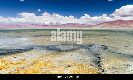Laguna Santa Rosa on the high-altitude salt flat plateau in the Nevado Tres Cruces National Park (Chile) with volcanic landscape on the background Stock Photo