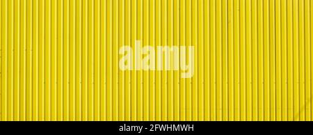 Yellow steel curtain wall panel. Abstract wide image of metal profile. Stock Photo