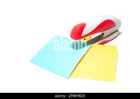 stapler with colorful leaves on a white background Stock Photo