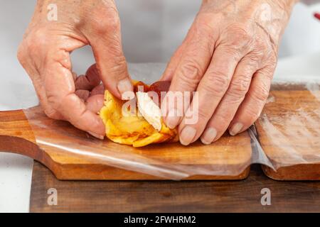 Senior woman preparing a traditional dish from el Valle del Cauca in Colombia called aborrajado Stock Photo