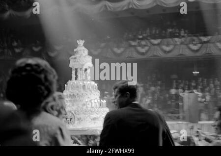 President John F. Kennedy attends a Democratic Party fund-raising dinner and birthday salute in his honor at Madison Square Garden in New York City, New York. The President’s cake is visible in the background. Stock Photo