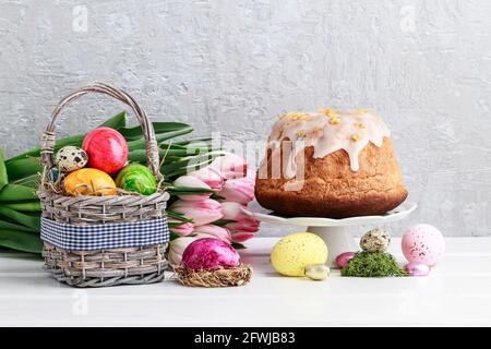 Basket of Easter eggs and traditional festive cake. Festive decor Stock Photo