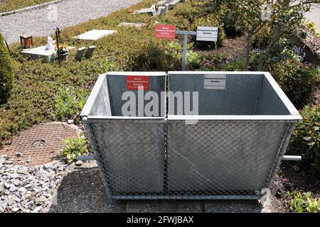 Front view of two metal containers with labels for compostable waste and non compostable waste. Stock Photo