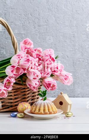 Easter festive table with traditional cake and flower decorations. Festive decor Stock Photo