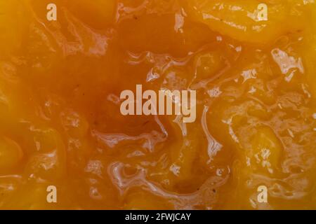Apricot Marmalde Structure on Top of Opened Jar. Macro Photo From Top. Stock Photo