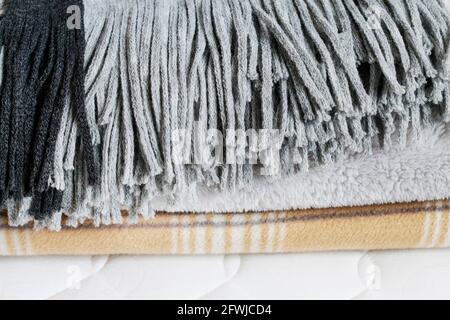 Three blankets: grey and beige on the mattress. Graphic resources Stock Photo