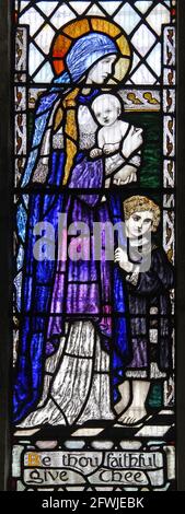 Stained glass window by Christopher Whall, 1923, depicting Faith; St Mary's Church Burton Bradstock; Stock Photo