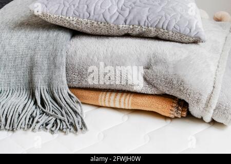 Soft blankets and grey pillow on the new mattress. Graphic resources Stock Photo