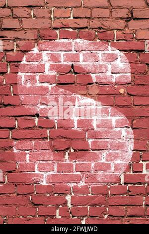 The letter S painted white on a red brick wall Stock Photo