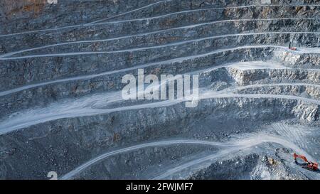 Striped pattern of terraces in open pit stone quarry, industrial background Stock Photo