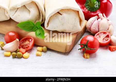 A burrito - mexican dish that consists of a flour tortilla with various ingredients. Traditional dish Stock Photo