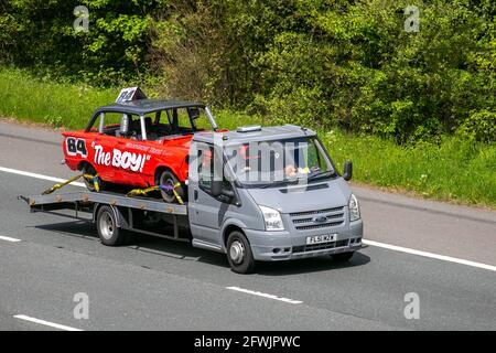 2001 Ford Transit 350 white LCV High roof van, carrying WoodGrove Taxis No. 84 'The Boy' Stock car; Vehicular traffic, moving vehicles, cars, vehicle driving on UK roads, motors, motoring on the M6 motorway highway UK road network. Stock Photo