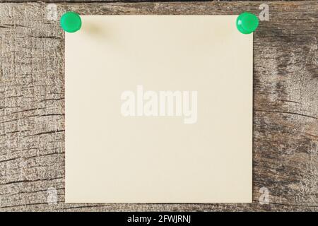 Square sticker pinned in a row on a wooden table. The concept of setting goals and objectives Stock Photo