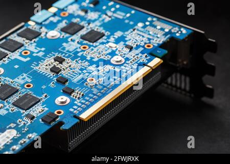 Chips and microprocessors on the blue Graphics card board. Components and electronic parts for PC repair, repair and maintenance Stock Photo