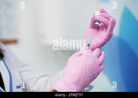 Aesthetic doctor preparing the syringe with the botulinum toxin. Stock Photo