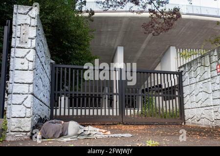 Shinjuku, Tokyo, Japan. 24th Oct, 2014. A homeless man sleeps by the old National Stadium in Gaiemmae, Shinjuku.The stadium has been demolished now and a new one, ready for the Tokyo 20202 Olympics has been built. Credit: Damon Coulter/SOPA Images/ZUMA Wire/Alamy Live News Stock Photo