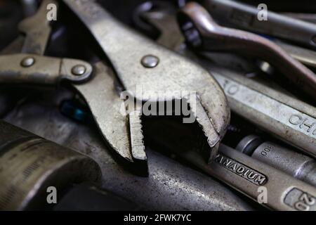 Kuwait City – Kuwait – April 15, 2021: Spanners and wrenches and other tools piled randomly in a drawer Stock Photo