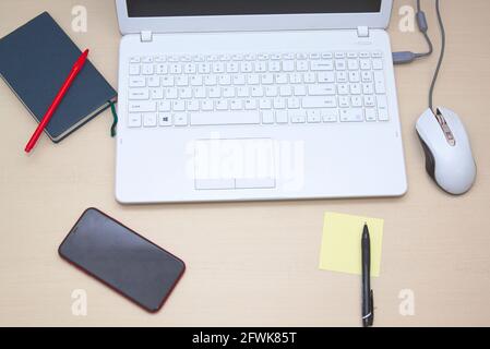 Stylish office desk with laptop, diary and workspace on white background. Flat lay Stock Photo