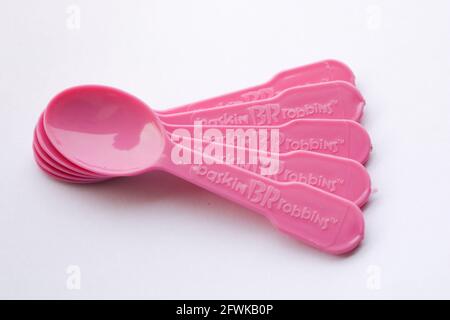 Multiple plastic spoons on isolated white background Stock Photo
