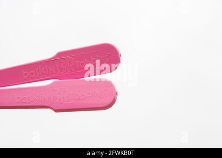 Plastic utensils, Pink plastic spoon on isolated white background Stock Photo