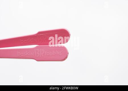 Plastic utensils, Pink plastic spoon on isolated white background Stock Photo