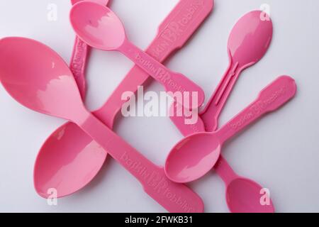 Lahore, Punjab, Pakistan - April 2, 2021: Pink Plastic spoons from Baskin Robbins on a white background Stock Photo