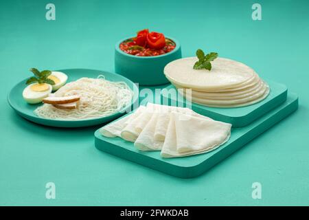 Rice Pathiri and Idiyappam, south indian malabar special breakfast made using rice flour which is white in colour, arranged in a aquamarine colour. Stock Photo